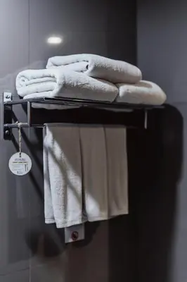 a towel rack with towels on it in a bathroom at The Lunar Patong in Patong Beach