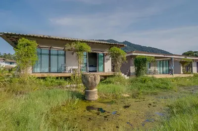a house in the middle of a field at Artisan koh yao yai handcraft beachfront villas. in Ban Lo Pa Ret