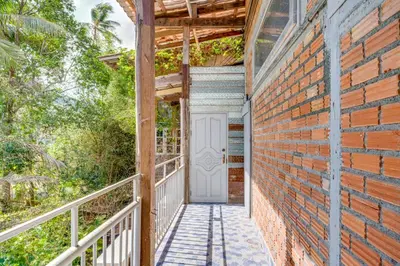 a brick house with a white door on a walkway at Artisan koh yao yai handcraft beachfront villas. in Ban Lo Pa Ret