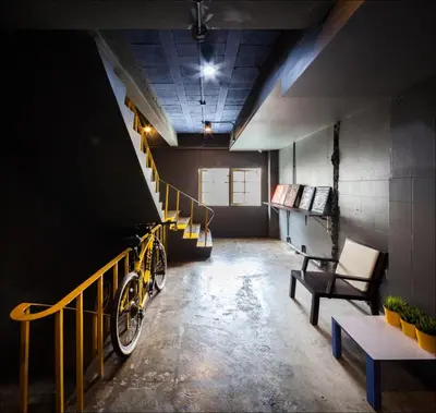 a room with a staircase and a yellow bike in it at Fulfill Phuket - SHA in Phuket Town