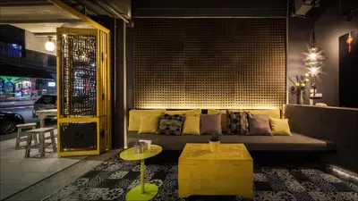 a living room with a couch and a table at Fulfill Phuket - SHA in Phuket Town