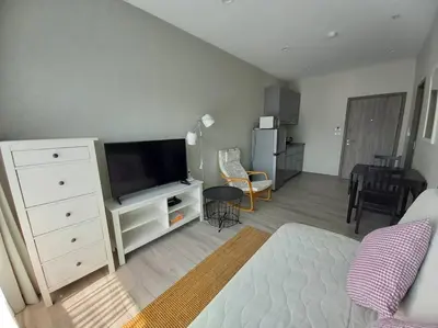 a living room with a white dresser and a flat screen tv at B6 НОВАЯ на БАССЕЙН ВАТСАП669З582I976 in Nai Yang Beach