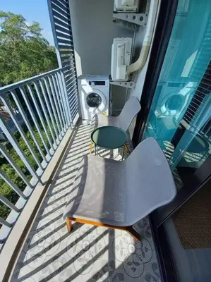 a balcony with a table and a chair on it at B6 НОВАЯ на БАССЕЙН ВАТСАП669З582I976 in Nai Yang Beach