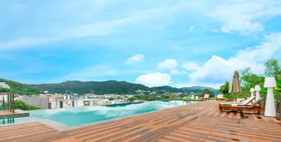 a view from the roof of a building with a swimming pool at Rudi Condo by Q Conzept in Kata Beach