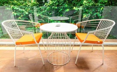 three chairs and a table and a table and chairs at Rudi Condo by Q Conzept in Kata Beach