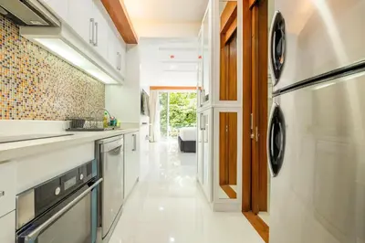 a kitchen with a sink and a dishwasher at Rudi Condo by Q Conzept in Kata Beach