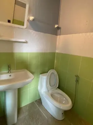 a bathroom with a white toilet and a sink at Phi Phi Goodview Bungalow in Phi Phi Don