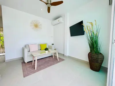 a living room with a couch and a coffee table at Baan Saint-Tropez Seaview Villas Kata Beach in Kata Beach