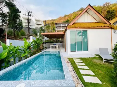 a swimming pool in the backyard of a house at Baan Saint-Tropez Seaview Villas Kata Beach in Kata Beach