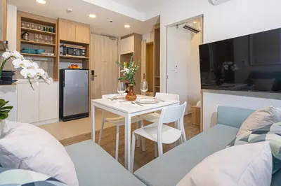 a kitchen and a living room with a table and chairs at Apartment in laguna , 600 metres from the beach in Phuket Town
