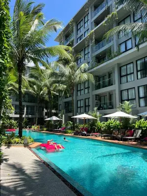a swimming pool in front of a building at 2-Bedroom Apartment in D Resort in Bang Tao Beach