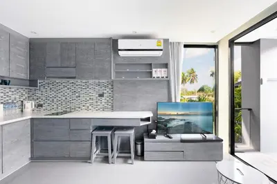 a kitchen with a kitchen island with a view of the ocean at City Gate Kamala D209 by Phuket Sabay Rent in Phuket Town