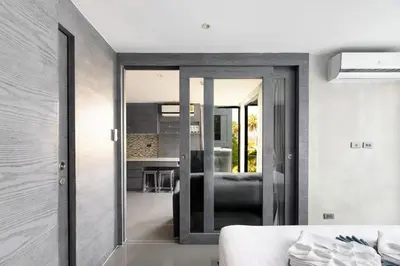 a bedroom with sliding glass doors leading into a living room at City Gate Kamala D209 by Phuket Sabay Rent in Phuket Town