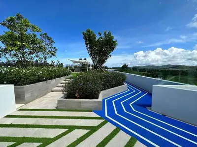 a walkway with blue and white stripes on a house at \u666e\u5409\u5c9bLaguna\u6d77\u6ee9\u8c6a\u534e\u5929\u9645\u6cf3\u6c60\u516c\u5bd3\uff0c\u5962\u534e\u4f53\u9a8c\u4e0e\u4f11\u95f2\u4e4b\u9009 in Phuket Town