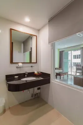 a bathroom with a sink and a mirror at Elite Suites Patong in Patong Beach