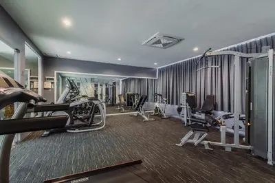 a gym with treadmills and elliptical machines at Elite Suites Patong in Patong Beach