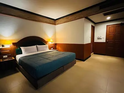 a bedroom with a large bed in a room at Sawasdee Apartment Patong in Patong Beach