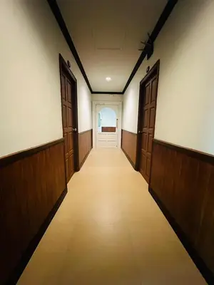 an empty hallway with wooden doors and a hallwayngth at Sawasdee Apartment Patong in Patong Beach