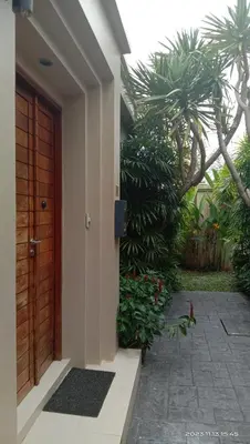 a door to a house with palm trees and a courtyard at Villa 242 - private pool, fast internet in Ban Thalat Choeng Thale