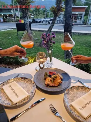 a table with plates of food and glasses of wine at Villa 242 - private pool, fast internet in Ban Thalat Choeng Thale