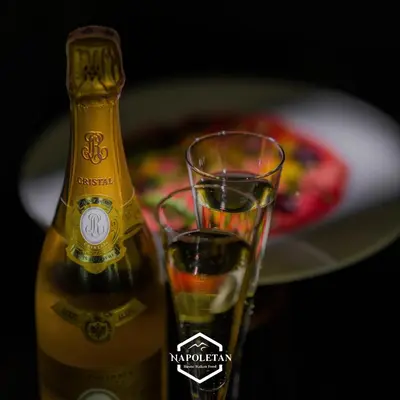 a bottle of champagne and a glass on a table at Villa 242 - private pool, fast internet in Ban Thalat Choeng Thale