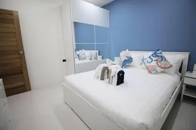 a bedroom with a large white bed with a mirror at Stylish Pool Villa - 10 Minutes walk to the Beach in Kamala Beach