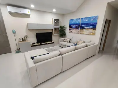 a living room with a white couch and a tv at Stylish Pool Villa - 10 Minutes walk to the Beach in Kamala Beach