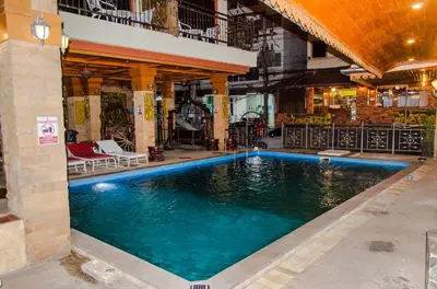 a swimming pool in the middle of a building at Diva Patong Hotel in Patong Beach