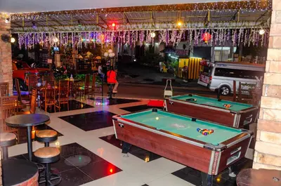 a bar with a pool table in a room at Diva Patong Hotel in Patong Beach