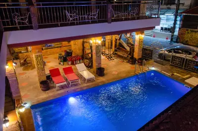 an overhead view of a swimming pool with two chairs at Diva Patong Hotel in Patong Beach