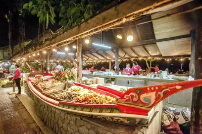 a restaurant with a table of food on a counter at Phi Phi Banyan Villa in Phi Phi Don