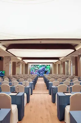 a room with blue tables and white chairs at Laya Resort Phuket in Layan Beach
