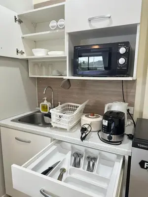 a small kitchen with a sink and a microwave at Kata Noi Place floor3 in Kata Beach