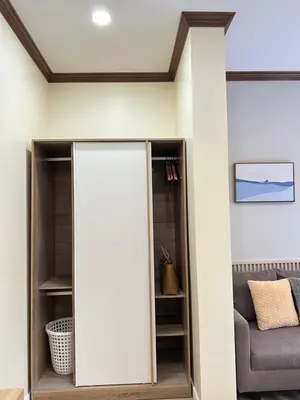 a living room with a pivot door in a wall at Kata Noi Place floor3 in Kata Beach