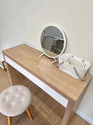 a dressing table with a mirror and a stool at Kata Noi Place floor3 in Kata Beach