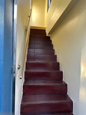 a staircase in a house with wooden steps at Kata Noi Place floor3 in Kata Beach
