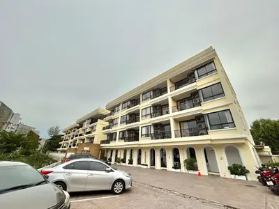 a large building with cars parked in front of it at Cozy 2 bedrooms walk to Nai Harn beach in Rawai Beach
