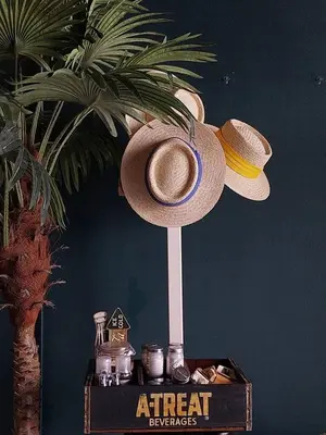 a hat on a stand on a table with a sign at W168 hostel in Ban Lo Long