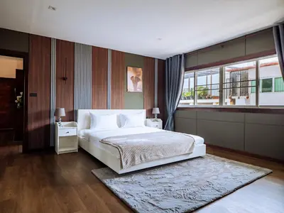 a bedroom with a white bed and a window at Grand Penthouse by Grand Orlov Apart in Patong Beach