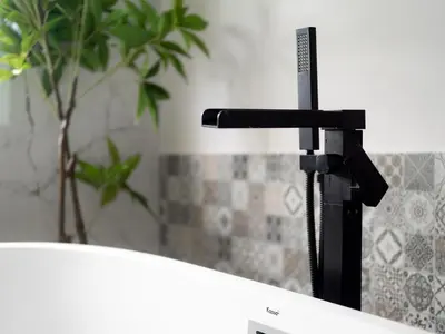 a black faucet next to a sink in a bathroom at Grand Penthouse by Grand Orlov Apart in Patong Beach