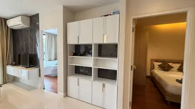 a bedroom with white cabinets and a bed in a room at 2 bed room the lago naiharn beach in Nai Harn Beach