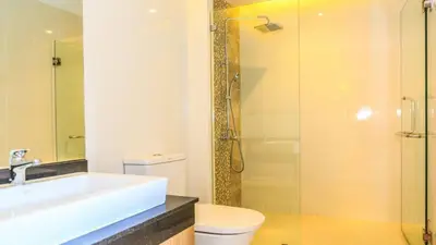 a bathroom with a sink and a toilet and a shower at 2 bed room the lago naiharn beach in Nai Harn Beach