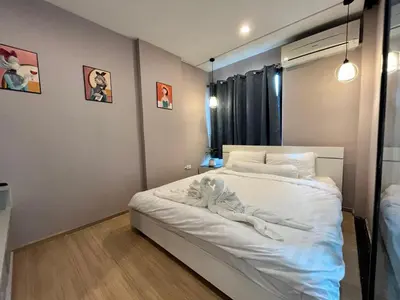 a bedroom with a bed with a towel on it at Zcape1 boat avenue in Ban Thalat Choeng Thale