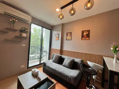a living room with a couch and a table at Zcape1 boat avenue in Ban Thalat Choeng Thale