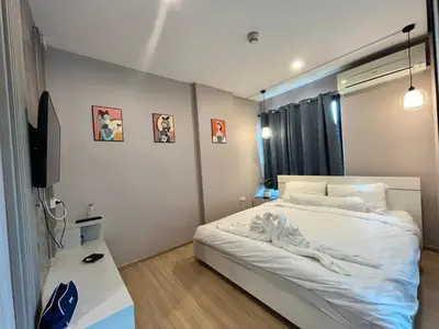 a small bedroom with a bed and a tv at Zcape1 boat avenue in Ban Thalat Choeng Thale