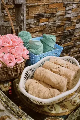 a table topped with baskets of pastries and flowers at Sasimanta in Kamala Beach