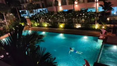 a person swimming in a swimming pool at night at Phuket Villa Patong Beach by Naphat in Patong Beach