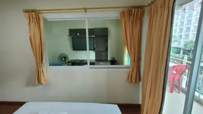 a bedroom with a window with a view of a kitchen at Phuket Villa Patong Beach by Naphat in Patong Beach