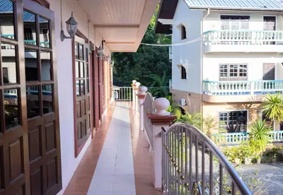 an empty balcony of a house with a railing at G house guest house in Patong Beach