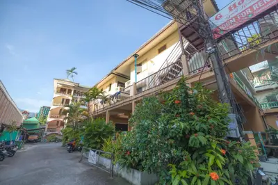 a building with plants on the side of it at G house guest house in Patong Beach